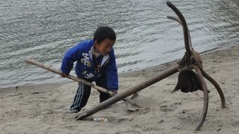 boy with a shovel on the beach
