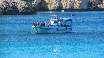 touristic boat on the blue sea near the cape greco