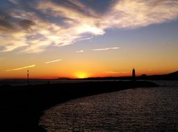 white clouds over bright colorful sunset on horizon