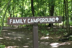 sign in the woods for camping