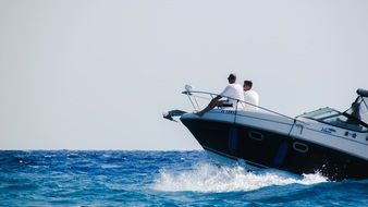 people ride a speed boat
