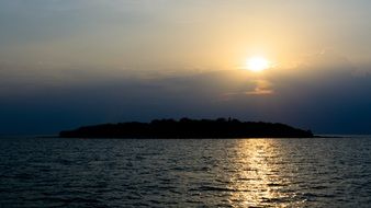 sunset over an island in thailand