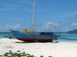 boat on the white sand on the coast of Seychelles