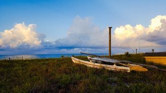 boat on the coast of the island of St. George with the clouds above the water