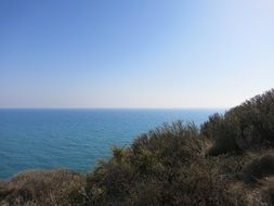 bright sun over the coast of sicily