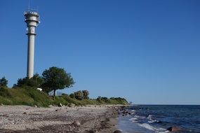 high lighthouse on the coast of the baltic sea