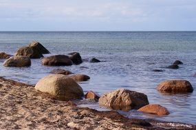 large round boulders by the ocean at sunrise