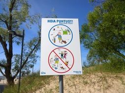 sign prohibiting dog walking on the beach