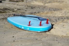 board with a paddle for surfing