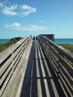 Beach broadwalk and blue sky with the clouds
