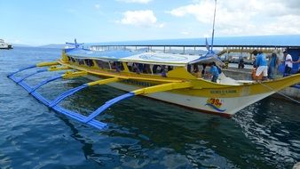 bright fishing boat off the coast