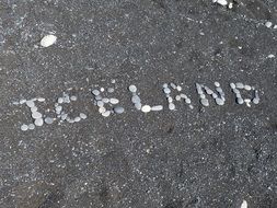 Iceland sign made of pebbles