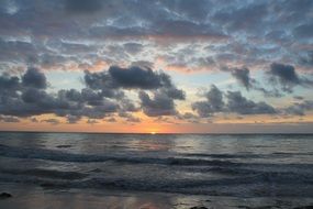 Beautiful sunrise in the clouds on the beach