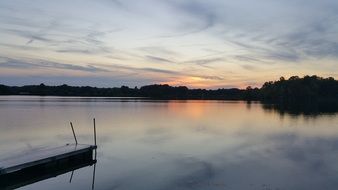 sunset over the quiet water of the lake