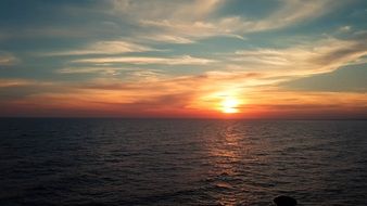 photo of sunset over the pier in Brighton, England