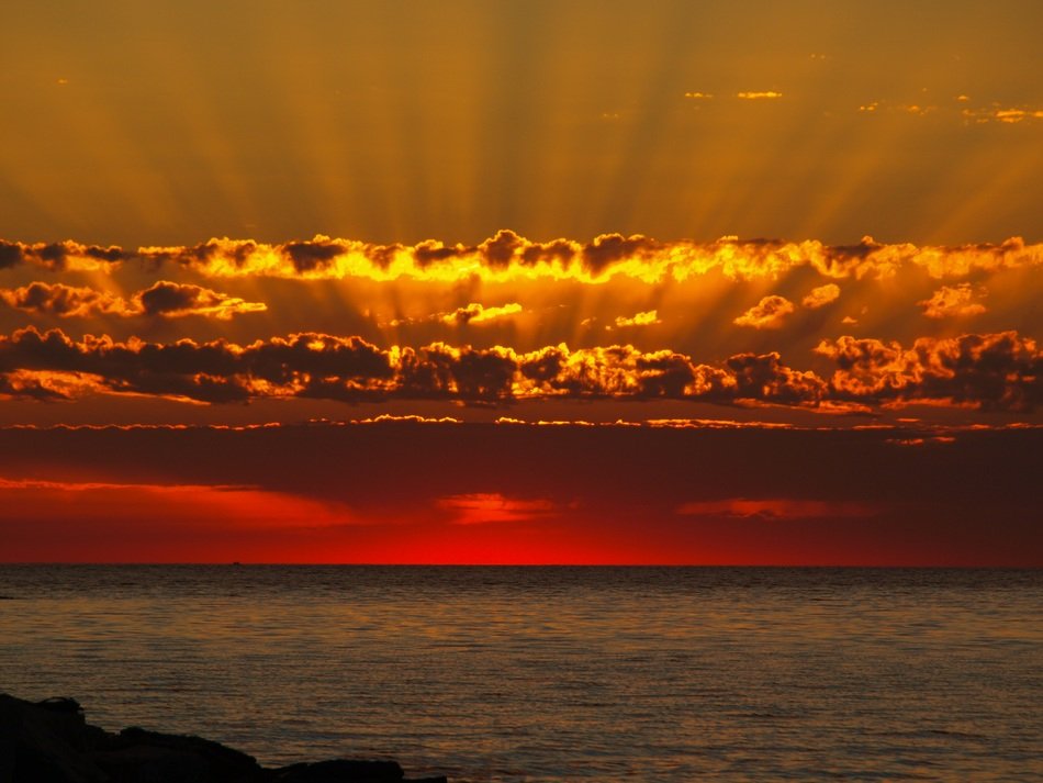 Seascape with the sunbeam in the clouds