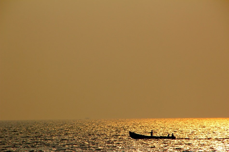 boat in the ocean at golden sunset