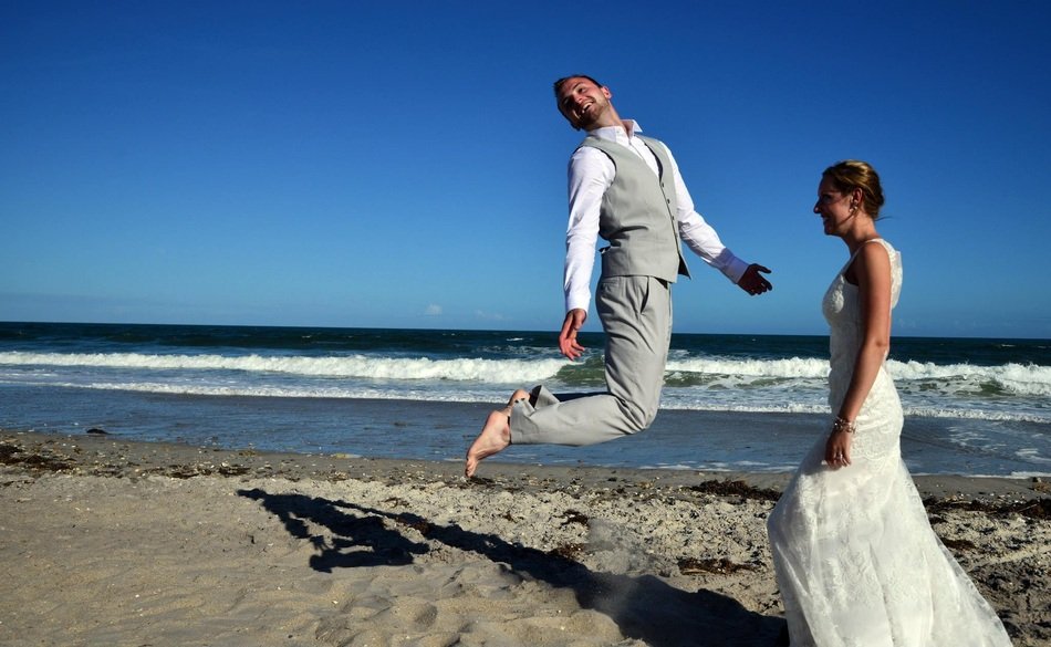 newlyweds on the beach on a sunny day