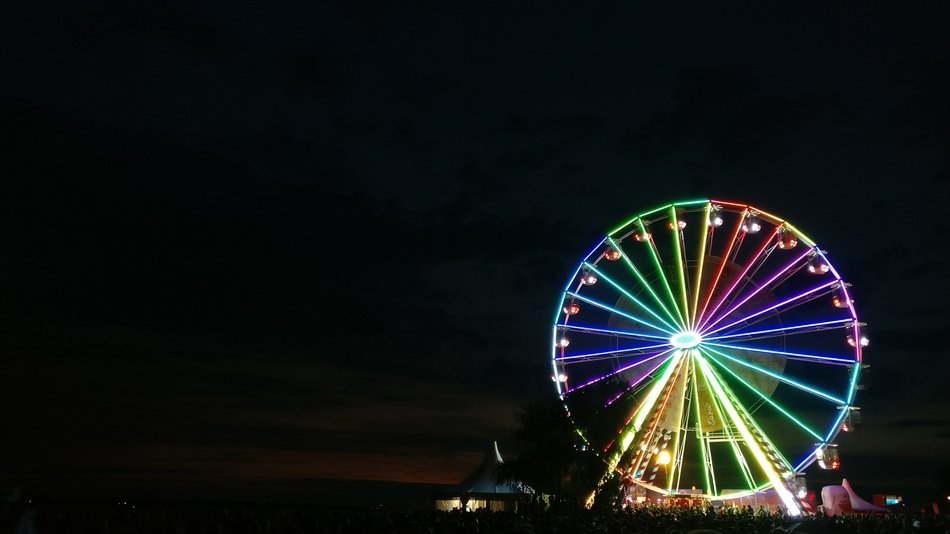 The Ferris wheel glows with bright lights