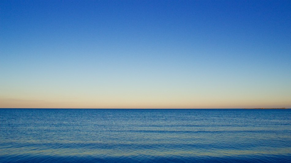 landscape of blue water and clear cloudless sky