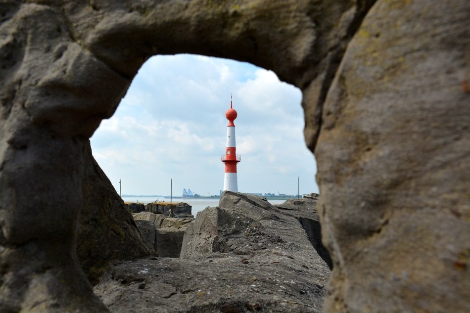 view of the lighthouse through the stone arch in Bremen