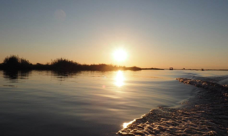 sun on the horizon above the water