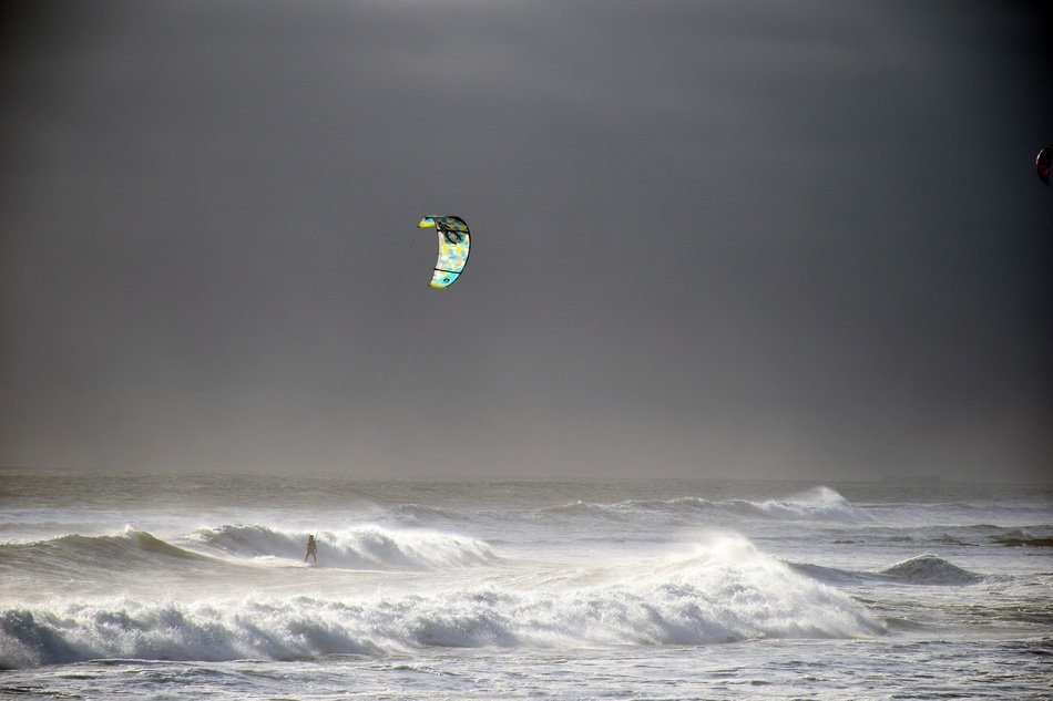 black and white photo of windsurfing on the ocean