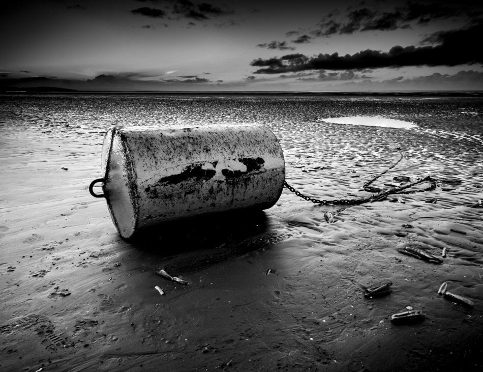 Black and white landscape with the bouy on the beach