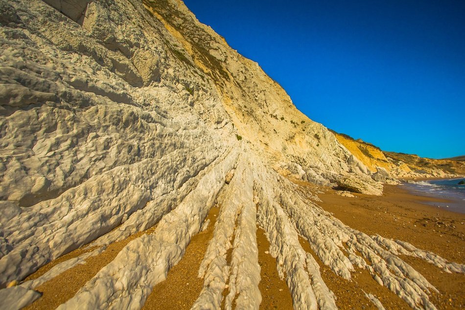 Worbarrow Bay Reefs at blue sky background