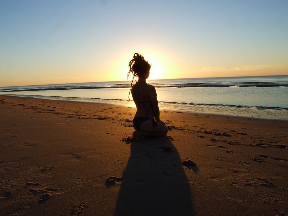 girl with hair on the beach meets the dawn