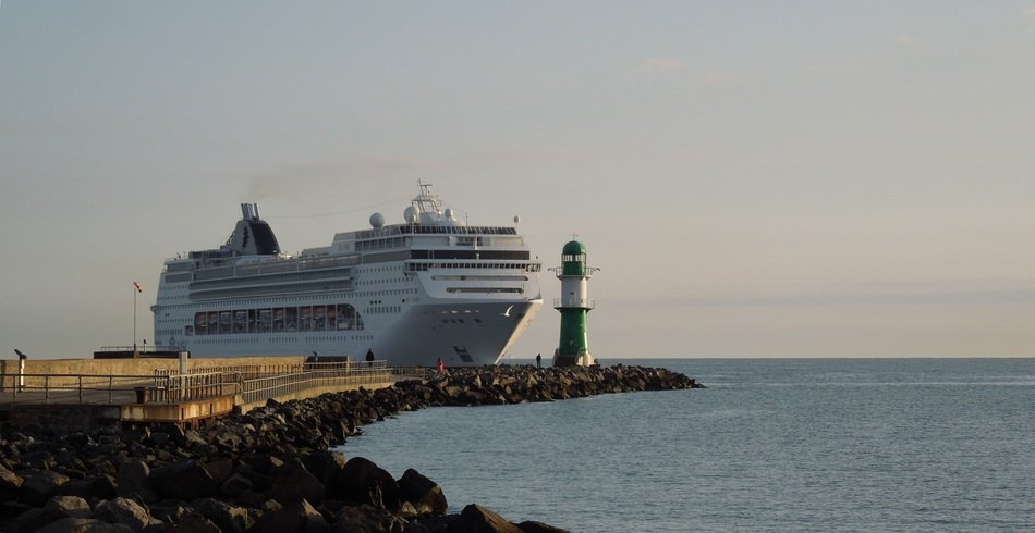 lighthouse on the background of a cruise ship
