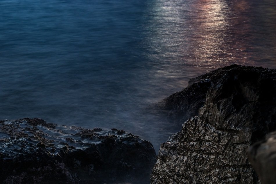 Landscape of the rocky beach at the sunset