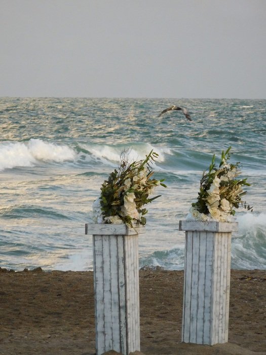wedding columns with flowers on the beach