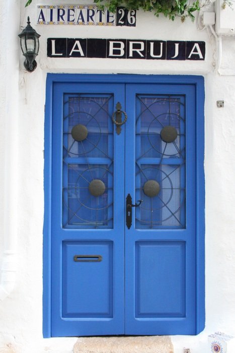 Blue door with 'LA BRUJA' sign
