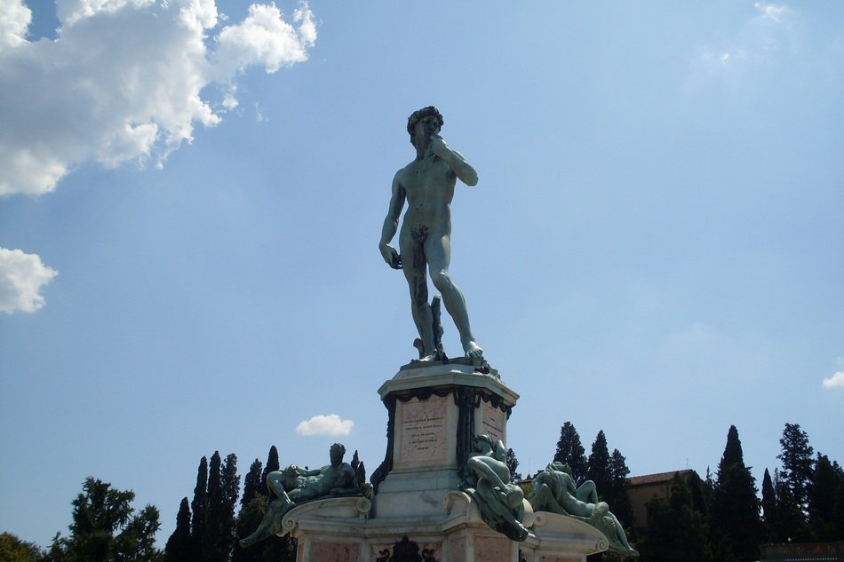 Michelangelo Statue with trees and buildings on the background