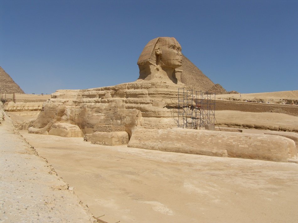 distant view of the Sphinx on the background of the pyramids