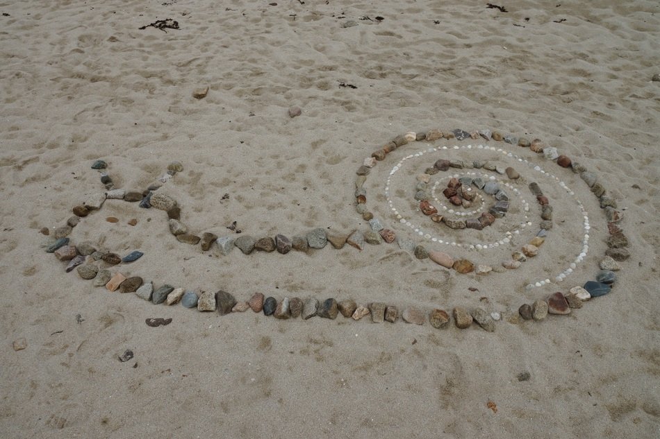 Snail made of the stones on the beach