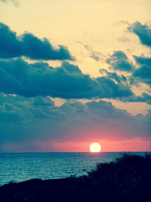 sunrise in the clouds over sardinia