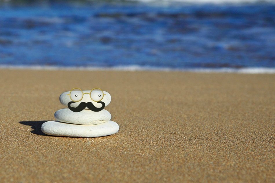 figure of white stones with a mustache on the beach