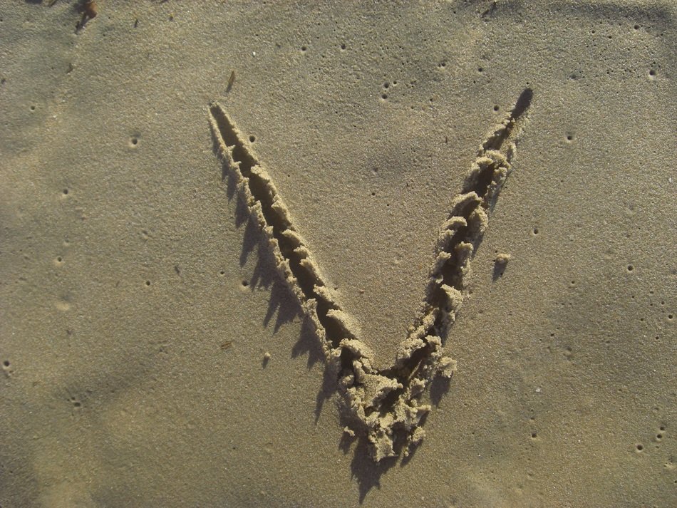 Letter V on the Sand