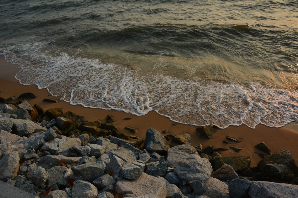 surf on stones at dusk