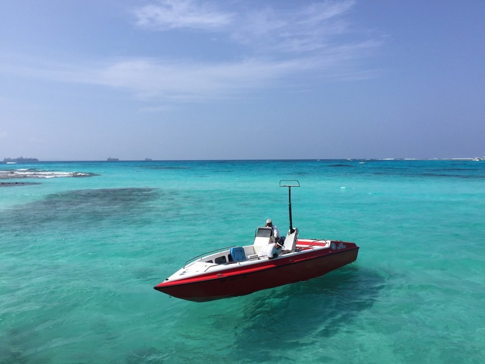 red motor boat on clear blue water, usa, Guam
