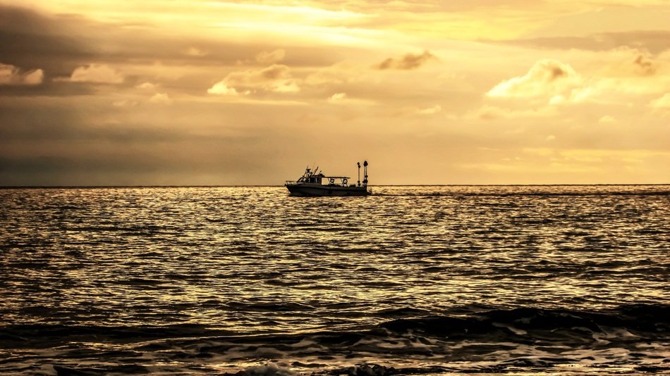 boat in the sea at sunset