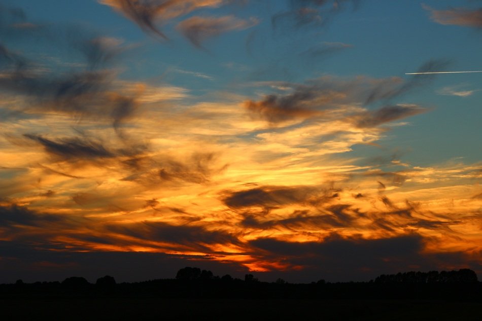 orange sunset behind the clouds