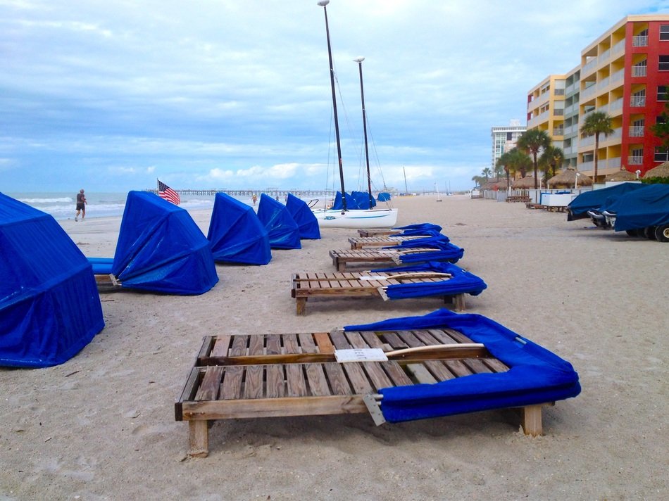 sun loungers on the beach in florida on a cloudy day