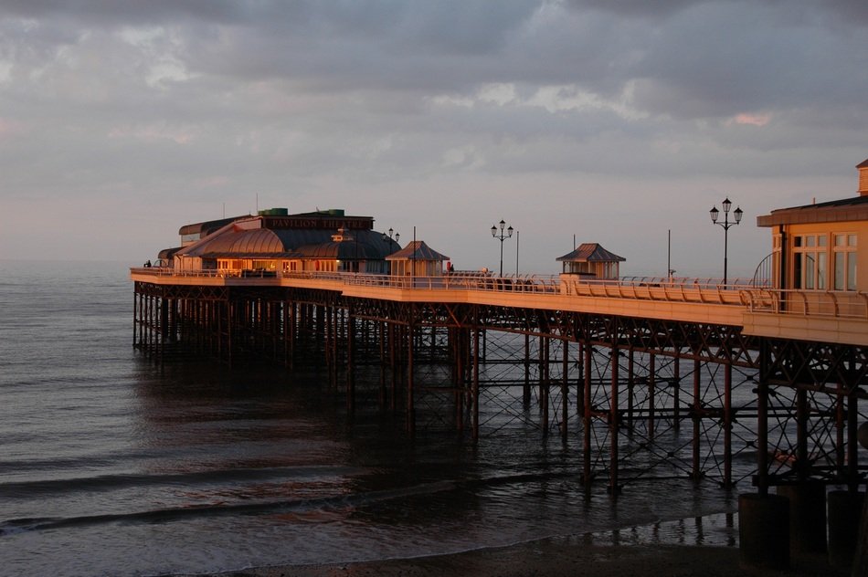 sunset over the pier in cromer