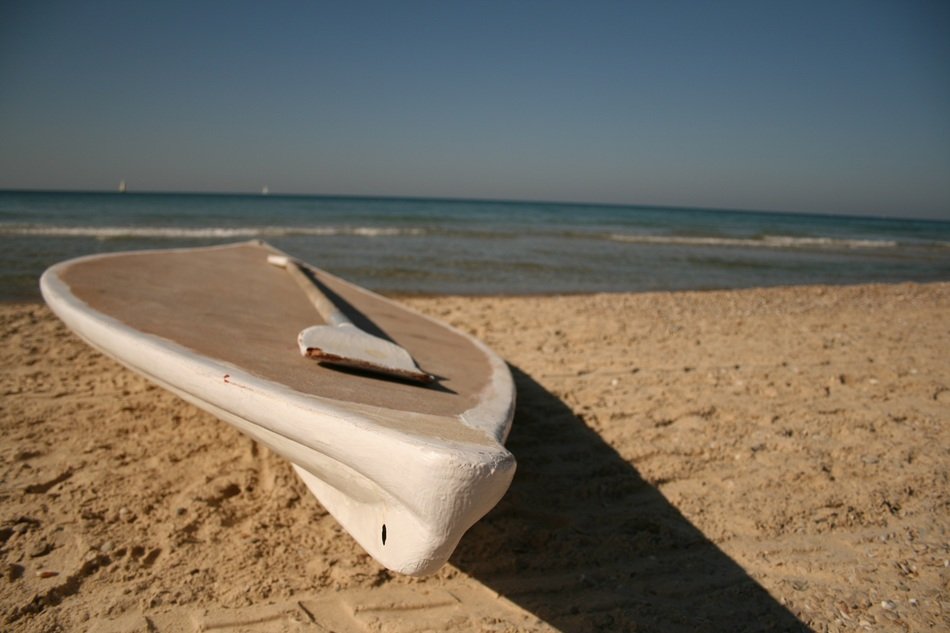 White boat on the sand on the beach