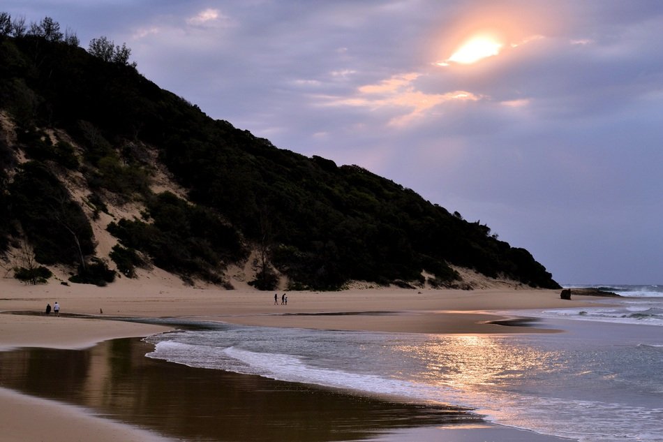 sunrise through the clouds over the beach