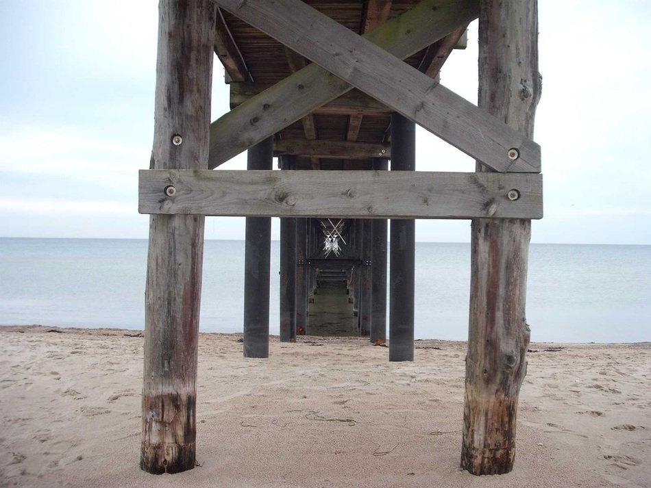 under a wooden pier on the North sea