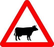 black silhouette of cow on red triangular traffic sign